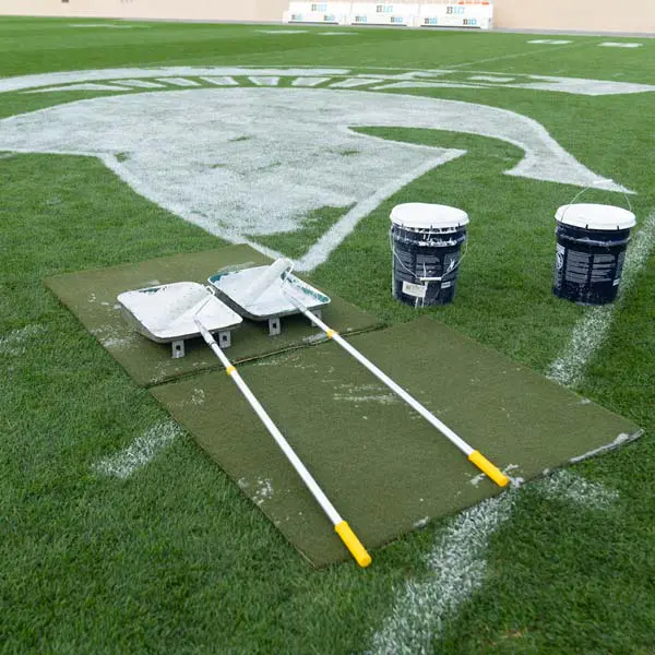 paint buckets on the field with rollers