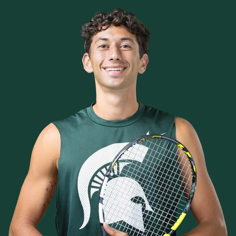 Ozan Baris posing in jersey with racket